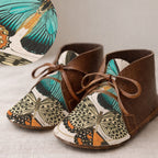 Children's shoes with butterfly pattern on a neutral background