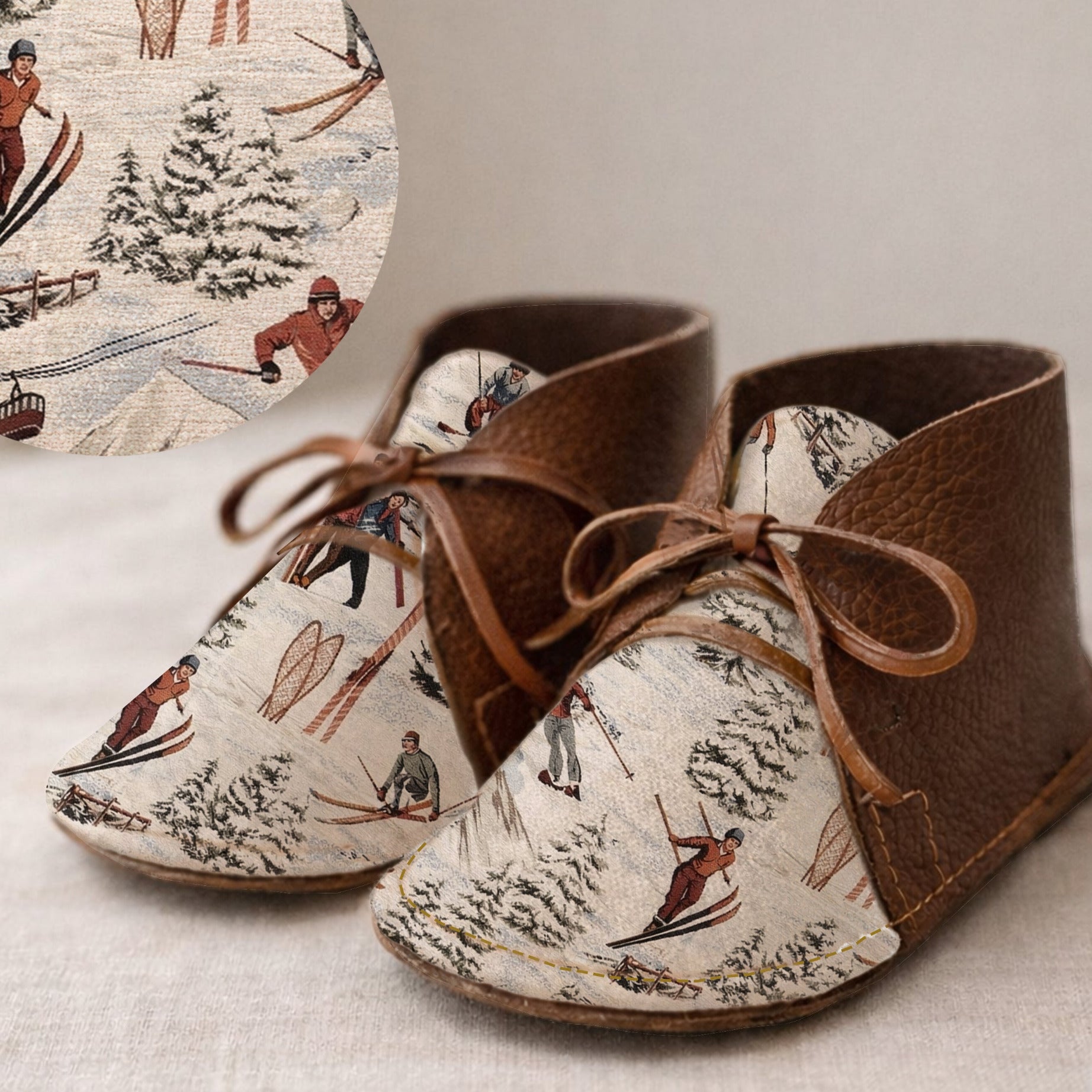 Pair of brown shoes with ski-themed pattern on a textured surface